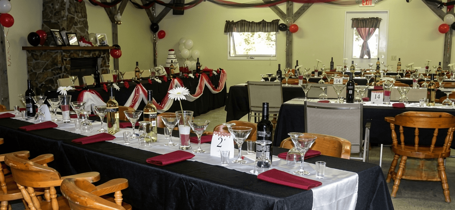 hall Decorated banquet hall with tables set for a formal event featuring black and red accents.